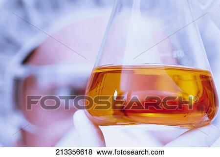 Scientist examining the sample in a conical flask View Large Photo Image Stock Photo - Scientist examining the sample in a conical flask. Fotosearch
