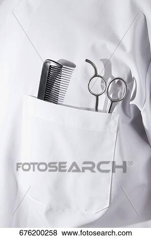 Stock Photo - Scissors and a comb in a barber's pocket. Fotosearch
