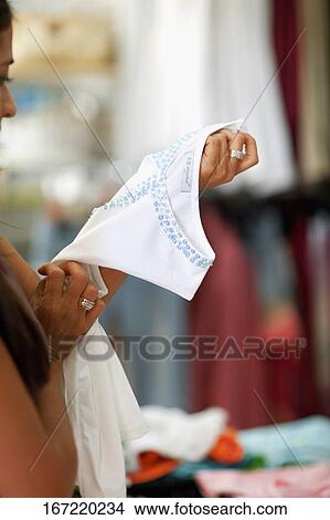 Side profile of a mid adult woman holding a top, Madrid, Spain View Large Photo Image Picture - Side profile of a mid adult woman holding a top, Madrid, Spain. Fotosearch