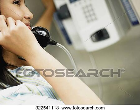 Stock Photo - Side profile of a teenage girl talking on the telephone. Fotosearch