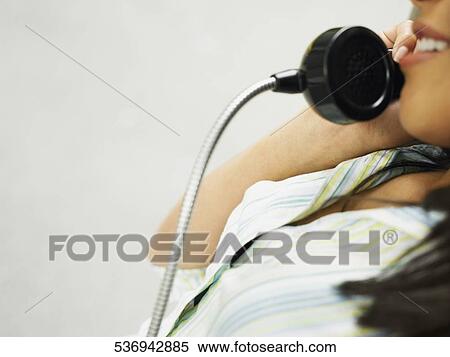 Side profile of a teenage girl talking on the telephone View Large Photo Image Stock Photography - Side profile of a teenage girl talking on the telephone. Fotosearch