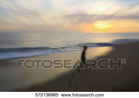 Silhouette of a boy walking on the beach View Large Photo Image Stock Photography - Silhouette of a boy walking on the beach. Fotosearch
