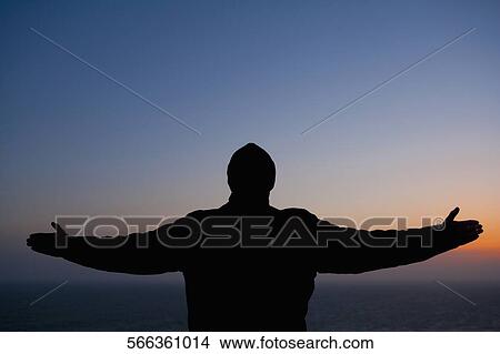 Silhouette of a man standing with his arms outstretched, San Francisco Bay, San Francisco, California, USA View Large Photo Image Picture - Silhouette of a man standing with his arms outstretched, San Francisco Bay, San Francisco, California, USA. Fotosearch