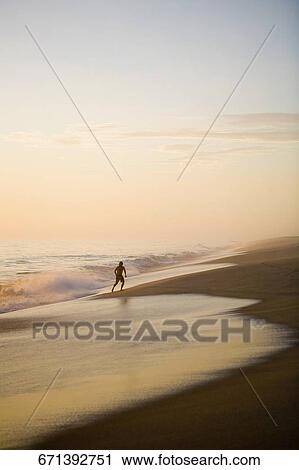 Silhouette of a running boy on the beach View Large Photo Image Stock Image - Silhouette of a running boy on the beach. Fotosearch