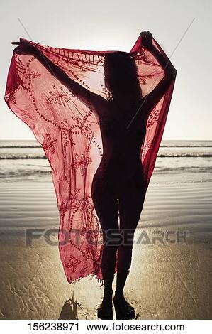 Silhouette of a woman holding a sarong on the beach View Large Photo Image Stock Image - Silhouette of a woman holding a sarong on the beach. Fotosearch