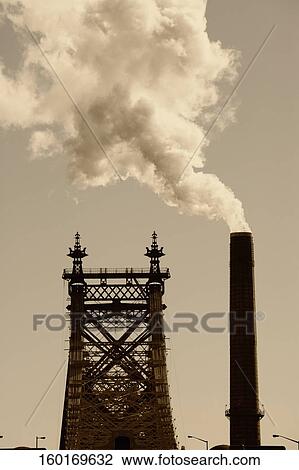 Smoke emerging from a chimney next to a bridge View Large Photo Image Stock Image - Smoke emerging from a chimney next to a bridge. Fotosearch