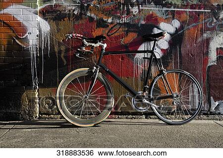 Sports bicycle leaning against a wall View Large Photo Image Stock Photograph - Sports bicycle leaning against a wall. Fotosearch