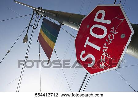 Stock Image - Stop sign with a rainbow colored flag on a pole, Castro District, San Francisco, California, USA. Fotosearch