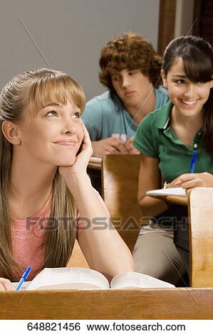 Student day dreaming in a classroom View Large Photo Image Stock Photograph - Student day dreaming in a classroom. Fotosearch