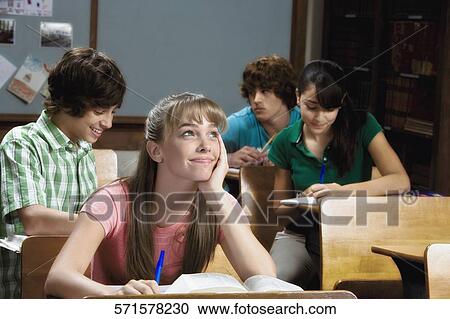 Student sitting in a classroom and day dreaming View Large Photo Image Stock Image - Student sitting in a classroom and day dreaming. Fotosearch