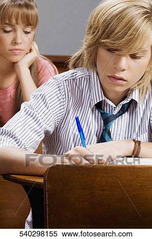 Stock Photography - Students giving exam in a classroom. Fotosearch