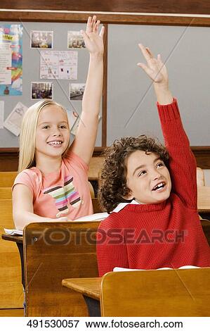 Students raising their hands in a classroom View Large Photo Image Stock Photo - Students raising their hands in a classroom. Fotosearch