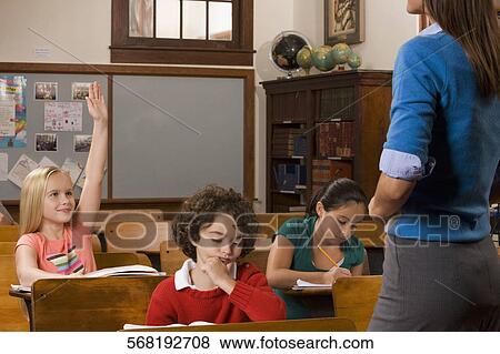 Students studying in a classroom with their teacher View Large Photo Image Stock Photo - Students studying in a classroom with their teacher. Fotosearch
