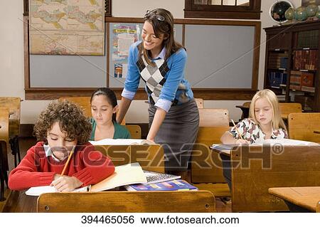 Students studying in a classroom with their teacher View Large Photo Image Stock Photograph - Students studying in a classroom with their teacher. Fotosearch
