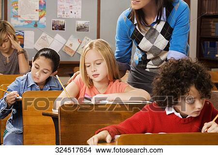 Students with their teacher in a classroom View Large Photo Image Picture - Students with their teacher in a classroom . Fotosearch