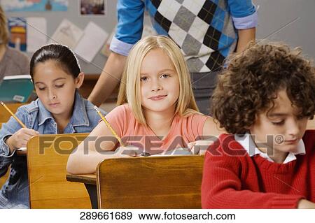 Students with their teacher in a classroom View Large Photo Image Stock Photo - Students with their teacher in a classroom . Fotosearch