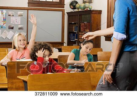 Students with their teacher in a classroom View Large Photo Image Stock Photo - Students with their teacher in a classroom . Fotosearch