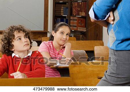Stock Photo - Students with their teacher in a classroom . Fotosearch