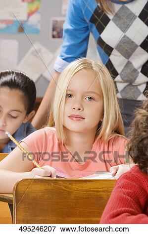Students with their teacher in a classroom View Large Photo Image Stock Photo - Students with their teacher in a classroom . Fotosearch