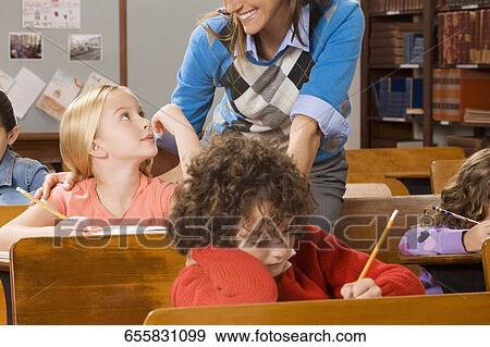 Students with their teacher in a classroom View Large Photo Image Stock Photo - Students with their teacher in a classroom . Fotosearch