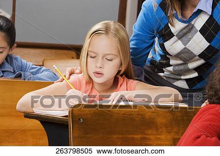 Students with their teacher in a classroom View Large Photo Image Stock Photography - Students with their teacher in a classroom . Fotosearch
