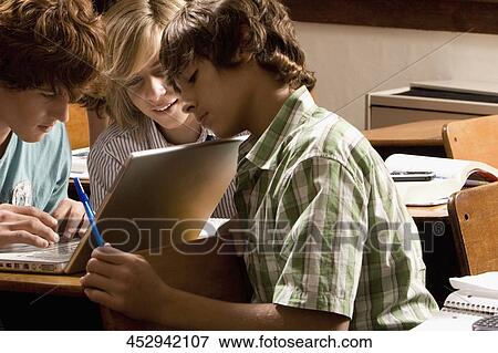Stock Photo - Students working on a laptop in the classroom. Fotosearch