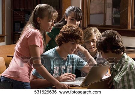 Students working on a laptop in the classroom View Large Photo Image Stock Photograph - Students working on a laptop in the classroom. Fotosearch