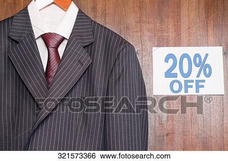Suit displayed with a Discount sign at a clothing store View Large Photo Image Stock Photograph - Suit displayed with a Discount sign at a clothing store. Fotosearch