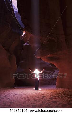 Sunbeam falling on a woman in a canyon, Antelope Canyon, Page, Arizona, USA View Large Photo Image Picture - Sunbeam falling on a woman in a canyon, Antelope Canyon, Page, Arizona, USA. Fotosearch