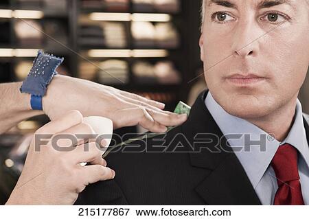 Tailor taking measurement of a businessman View Large Photo Image Stock Photo - Tailor taking measurement of a businessman. Fotosearch
