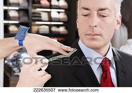 Tailor taking measurement of a businessman View Large Photo Image Stock Photo - Tailor taking measurement of a businessman. Fotosearch