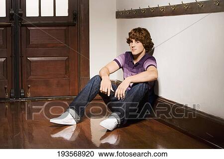 Teenage boy sitting in a school corridor View Large Photo Image Stock Image - Teenage boy sitting in a school corridor. Fotosearch