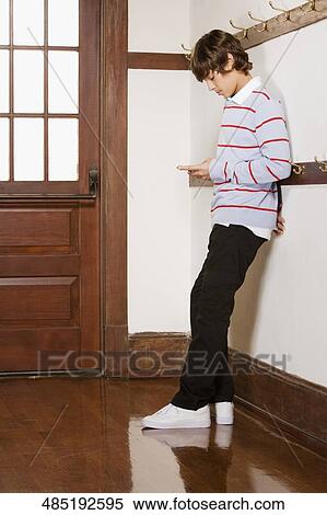 Teenage boy text messaging on a mobile phone View Large Photo Image Stock Photography - Teenage boy text messaging on a mobile phone. Fotosearch