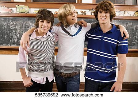 Teenage friends standing in a classroom and smiling View Large Photo Image Stock Image - Teenage friends standing in a classroom and smiling. Fotosearch