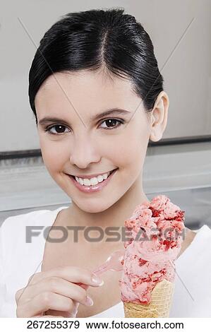 Teenage girl holding an ice cream View Large Photo Image Stock Photo - Teenage girl holding an ice cream. Fotosearch
