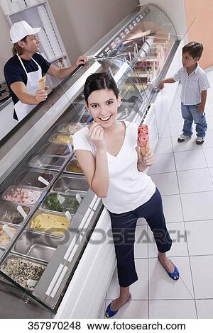 Teenage girl holding an ice cream View Large Photo Image Stock Photo - Teenage girl holding an ice cream. Fotosearch