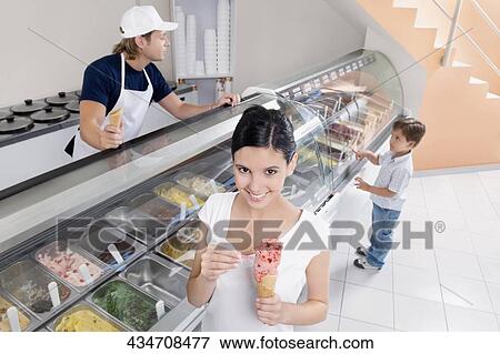 Teenage girl holding an ice cream View Large Photo Image Stock Photo - Teenage girl holding an ice cream. Fotosearch
