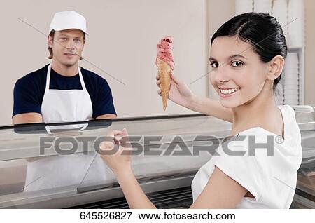 Teenage girl holding an ice cream View Large Photo Image Stock Photo - Teenage girl holding an ice cream. Fotosearch