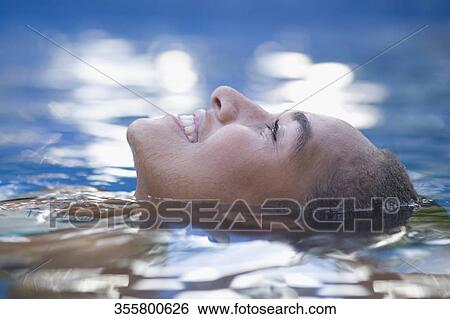 Teenage girl swimming in a pool and smiling View Large Photo Image Stock Photograph - Teenage girl swimming in a pool and smiling. Fotosearch