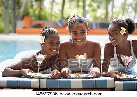 Teenage girl with her friends holding ice creams at the poolside View Large Photo Image Stock Photograph - Teenage girl with her friends holding ice creams at the poolside. Fotosearch