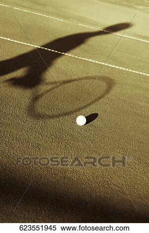 Tennis ball and the shadow of a tennis player in a court View Large Photo Image Stock Photography - Tennis ball and the shadow of a tennis player in a court. Fotosearch