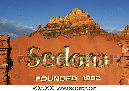 Stock Image - Text on a stone wall with rock formations in the background, Sedona, Arizona, USA. Fotosearch