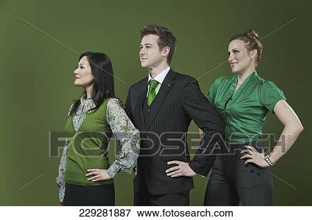 Three business executives standing in a row View Large Photo Image Stock Photo - Three business executives standing in a row. Fotosearch