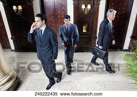 Three businessmen walking in a hotel lobby, Biltmore Hotel, Coral Gables, Florida, USA View Large Photo Image Stock Photography - Three businessmen walking in a hotel lobby, Biltmore Hotel, Coral Gables, Florida, USA. Fotosearch