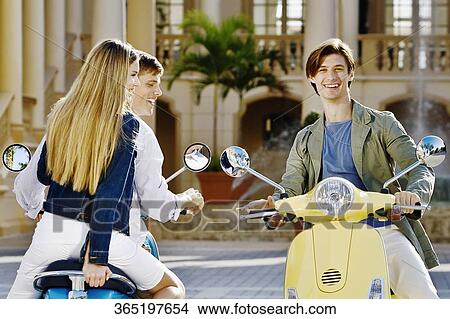 Picture - Three friends having fun on mopeds, Biltmore Hotel, Coral Gables, Florida, USA. Fotosearch