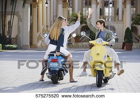 Three friends having fun on mopeds, Biltmore Hotel, Coral Gables, Florida, USA View Large Photo Image Stock Image - Three friends having fun on mopeds, Biltmore Hotel, Coral Gables, Florida, USA. Fotosearch