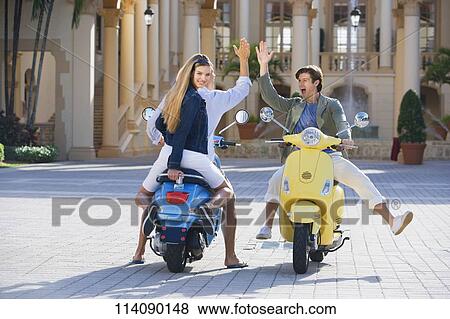 Three friends having fun on mopeds, Biltmore Hotel, Coral Gables, Florida, USA View Large Photo Image Stock Photo - Three friends having fun on mopeds, Biltmore Hotel, Coral Gables, Florida, USA. Fotosearch