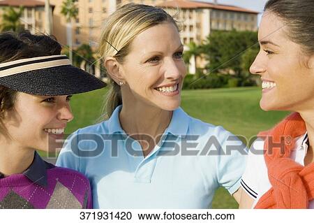 Stock Image - Three golfers smiling, Biltmore Golf Course, Biltmore Hotel, Coral Gables, Florida, USA. Fotosearch