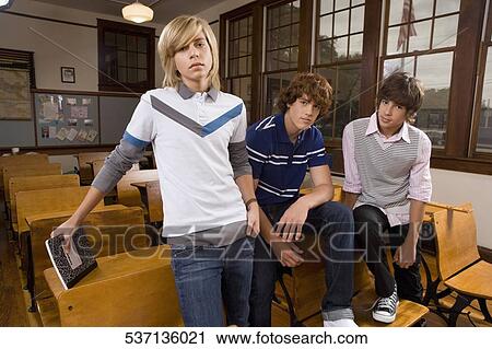 Three teenage boys in a classroom View Large Photo Image Stock Image - Three teenage boys in a classroom. Fotosearch