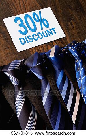 Stock Photography - Ties displayed with a Discount sign in a clothing store. Fotosearch